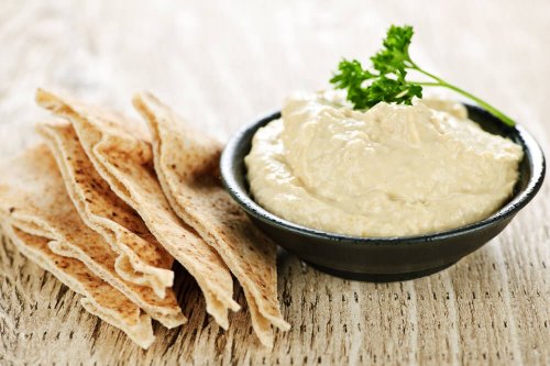 Hummus dip with pita bread slices
