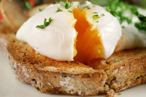 Poached egg with blanched spinach and shallots